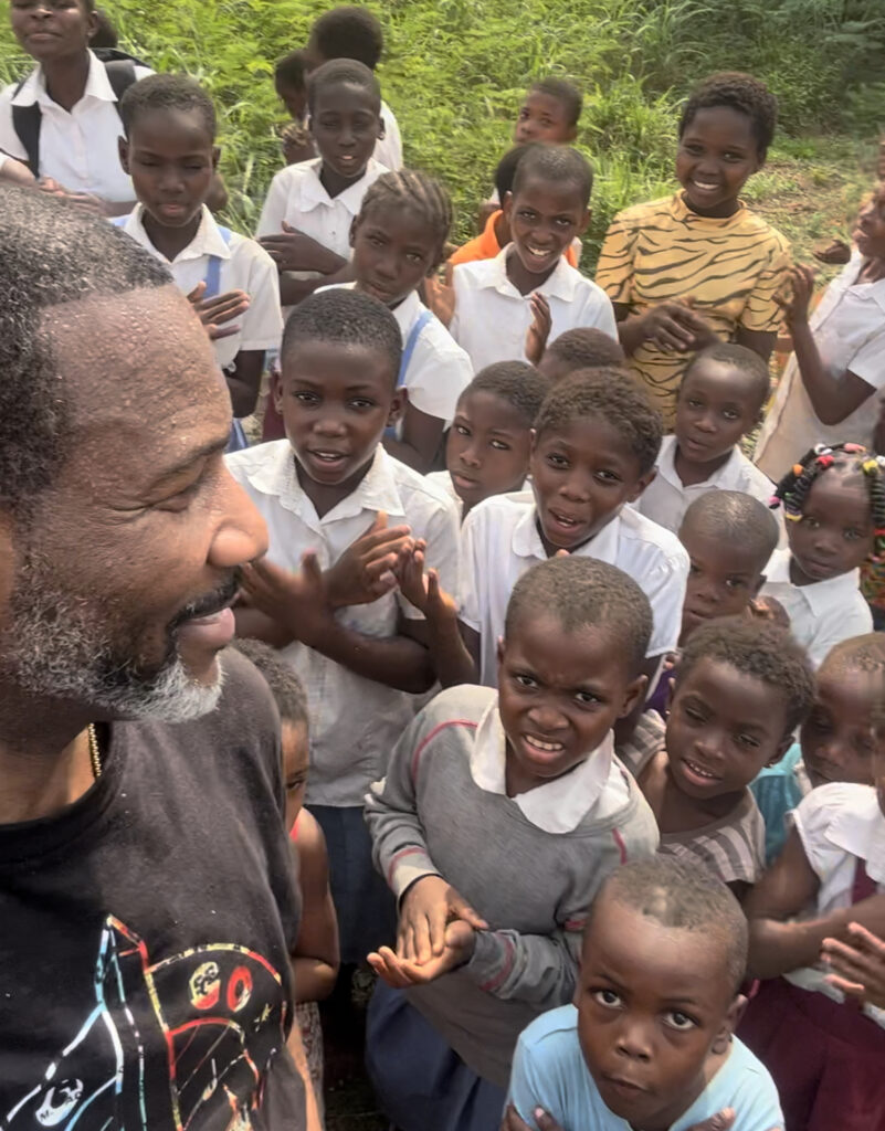 GRID Mid-Atlantic Logistics and Facilities Manager Sundiata Ramin (left) meets with local children while visiting Ghana in January 2024.