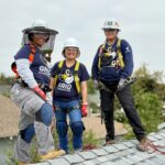 Women SolarCorps fellows on roof with safety equipment